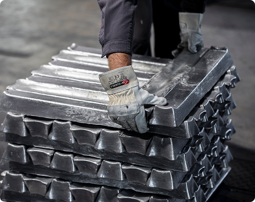 A worker handling stacked metal hardware